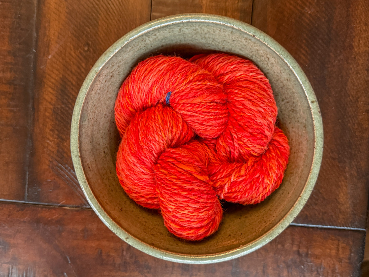 Red handspun yarn: 2-ply Corriedale wool, “Aziraphale”